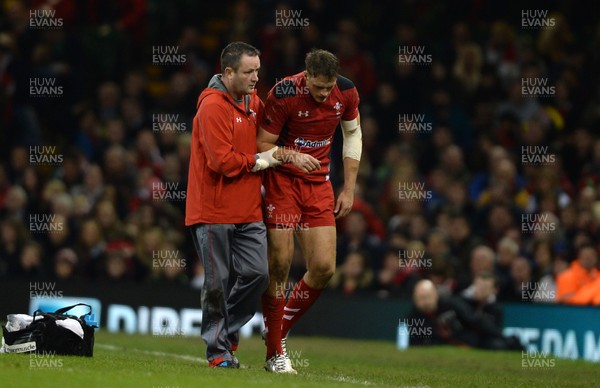 161113 - Wales v Argentina - Dove Men Series 2013 -Cory Allen of Wales is helped from the field by team doctor Geoff Davies