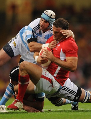 20.08.11 - Wales v Argentina - RWC Warm-Up Match - Jamie Roberts of Wales is tackled by Julio Farias Cabello and Juan Manuel Leduizamon of Argentina. 