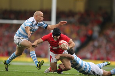 20.08.11 Wales v Argentina. Wales' Leigh Halfpenny is tackled by Argentina's Felipe Contepomi and Santiago Fernandez. 