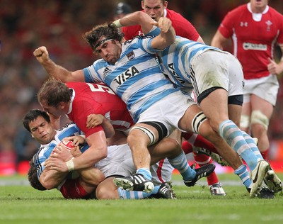 20.08.11 Wales v Argentina. Argentina's Nicolas Vergallo is tackled by George North and Alun Wyn Jones. 