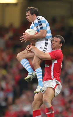 20.08.11 Wales v Argentina. Argentina's Horacio Agulla is tackled by Jamie Roberts. 