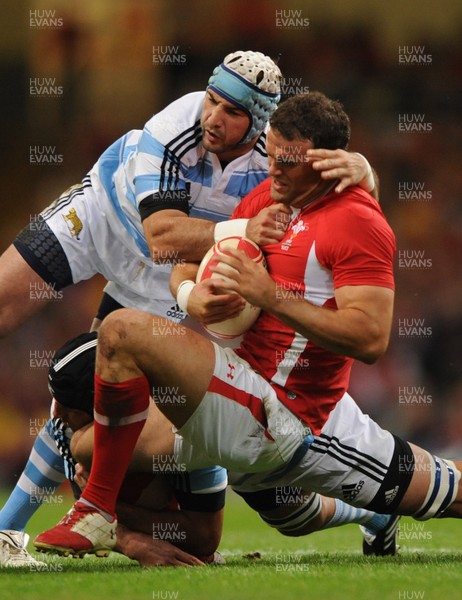 20.08.11 - Wales v Argentina - RWC Warm-Up Match - Jamie Roberts of Wales is tackled by Julio Farias Cabello and Juan Manuel Leduizamon of Argentina. 