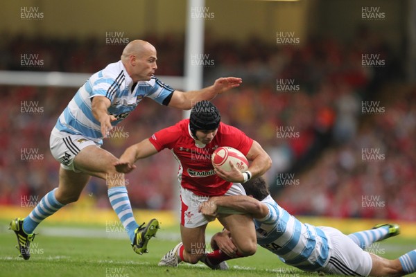 20.08.11 Wales v Argentina. Wales' Leigh Halfpenny is tackled by Argentina's Felipe Contepomi and Santiago Fernandez. 