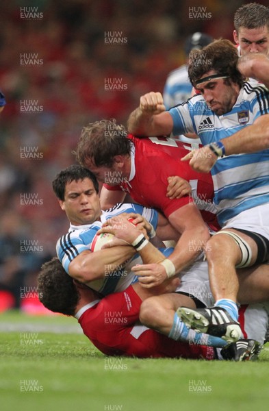 20.08.11 Wales v Argentina. Argentina's Nicolas Vergallo is tackled by George North and Alun Wyn Jones. 