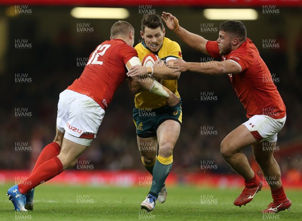 101118 - Wales v Australia - Under Armour Series 2018 - Bernard Foley of Australia is tackled by Hadleigh Parkes and Nicky Smith of Wales
