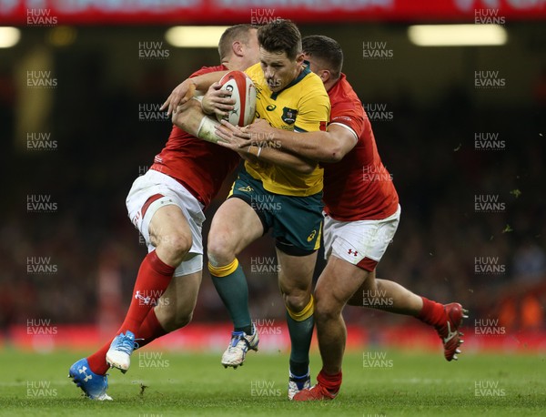 101118 - Wales v Australia - Under Armour Series 2018 - Bernard Foley of Australia is tackled by Hadleigh Parkes and Nicky Smith of Wales