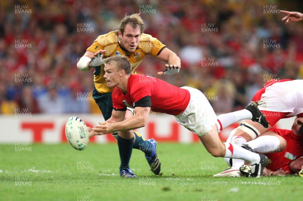 15.09.07 -Wales v Australia, RWC 2007 -  Wales' Dwayne Peel feeds the ball out as Rocky Elsom closes in 