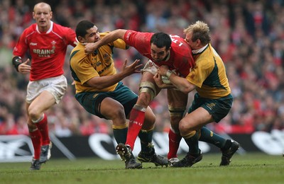 04.11.06  Wales v Australia, Invesco Perpetual Series 2006 Wales' Jonathan Thomas is tackled by Rodney Blake and Phil Waugh 