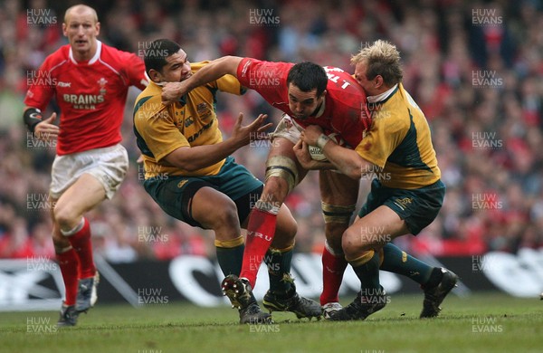 04.11.06  Wales v Australia, Invesco Perpetual Series 2006 Wales' Jonathan Thomas is tackled by Rodney Blake and Phil Waugh 