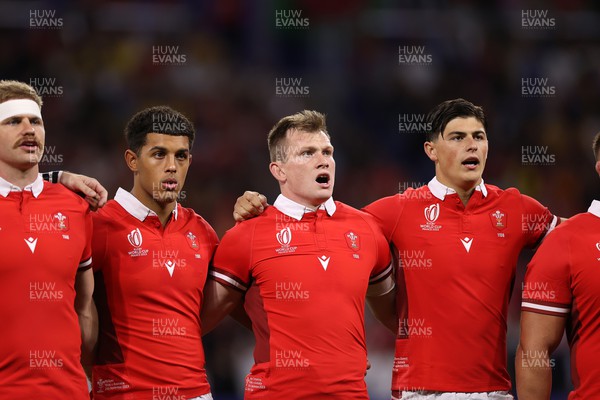 240923 - Wales v Australia - Rugby World Cup France 2023 - Pool C - Rio Dyer, Nick Tompkins and Louis Rees-Zammit of Wales sing the anthem