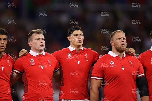 240923 - Wales v Australia - Rugby World Cup France 2023 - Pool C - Nick Tompkins, Louis Rees-Zammit and Corey Domachowski of Wales sing the anthem
