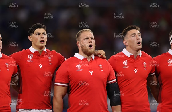 240923 - Wales v Australia - Rugby World Cup France 2023 - Pool C - Louis Rees-Zammit, Corey Domachowski and Josh Adams of Wales sing the anthem