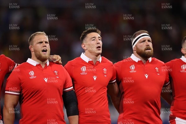 240923 - Wales v Australia - Rugby World Cup France 2023 - Pool C - Corey Domachowski, Josh Adams and Henry Thomas of Wales sing the anthem