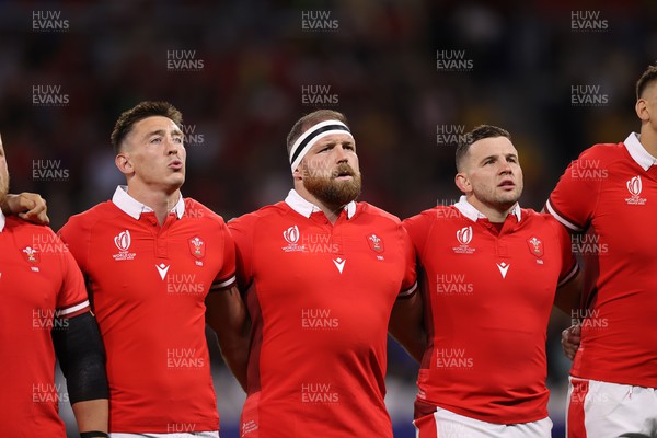 240923 - Wales v Australia - Rugby World Cup France 2023 - Pool C - Josh Adams, Henry Thomas and Elliot Dee of Wales sing the anthem