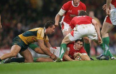 28.11.09  Wales v Australia... Wales James Hook looks for cover as Australia's Quade Cooper  comes in to tackle. 