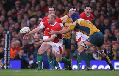 29.11.08 Wales v Australia... Wales' Martyn Williams passes as Australia's Nathan Sharpe tackles. 