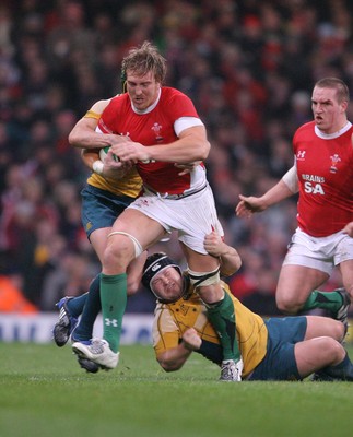 29.11.08 Wales v Australia... Wales' Andy Powell leaves Australia's Benn Robinson grounded. 
