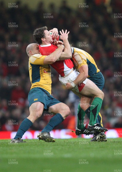 29.11.08 ... Wales v Australia, Invesco Perpetual Series 2008. -  Wales' Mark Jones is tackled by Australia's Phil Waugh and Stephen Moore  