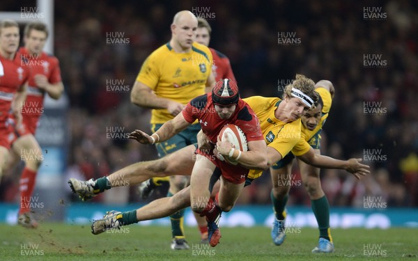 301113 - Wales v Australia - Dove Men Series 2013 -Leigh Halfpenny of Wales is tackled by Nick Cummins of Australia