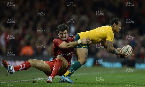 301113 - Wales v Australia - Dove Men Series 2013 -Will Genia of Australia is tackled by Mike Phillips of Wales