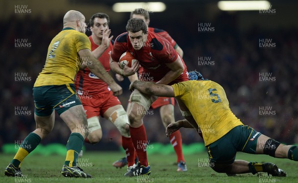 301113 - Wales v Australia - Dove Men Series 2013 -Ian Evans of Wales is tackled by Stephen Moore and James Horwill of Australia