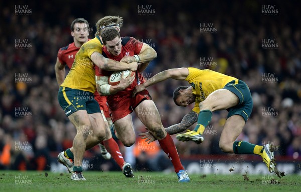 301113 - Wales v Australia - Dove Men Series 2013 -George North of Wales is tackled by Nick Cummins and Quade Cooper of Australia