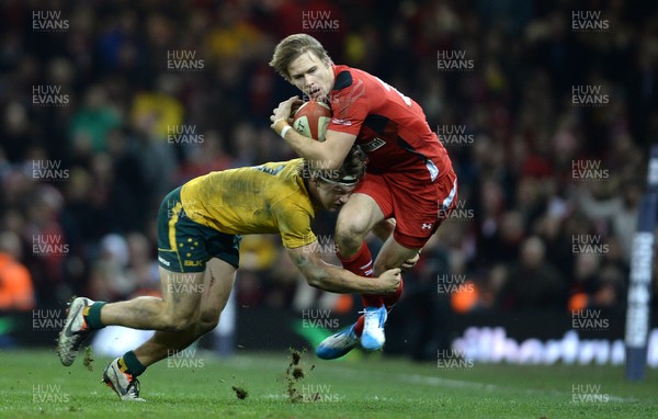 301113 - Wales v Australia - Dove Men Series 2013 -Liam Williams of Wales is tackled by Nick Cummins of Australia