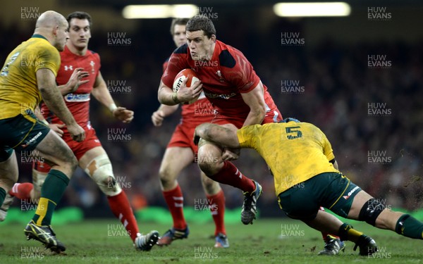 301113 - Wales v Australia - Dove Men Series 2013 -Ian Evans of Wales is tackled by Stephen Moore and James Horwill of Australia