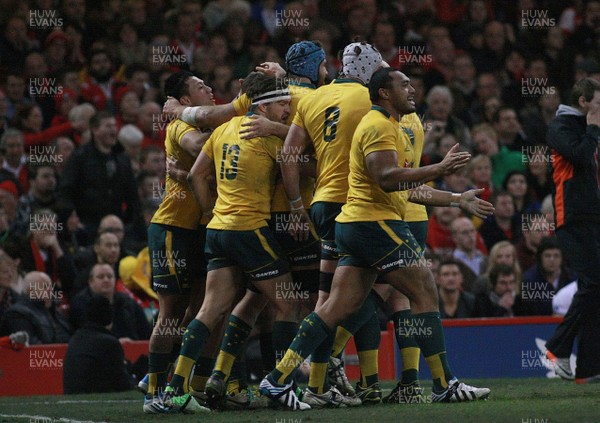 301113 - Wales v Australia - Dove Men+Care Series - Christian Leali'ifano of Australia(L) is congratulated by team mates