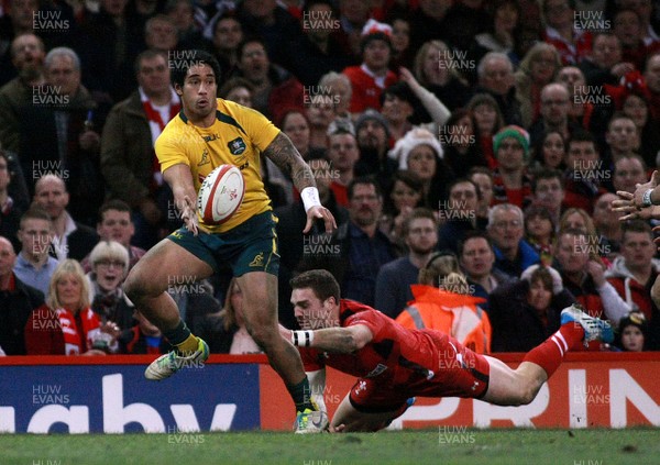 301113 - Wales v Australia - Dove Men+Care Series - Will Genia of Australia offloads as George North of Wales tackles 