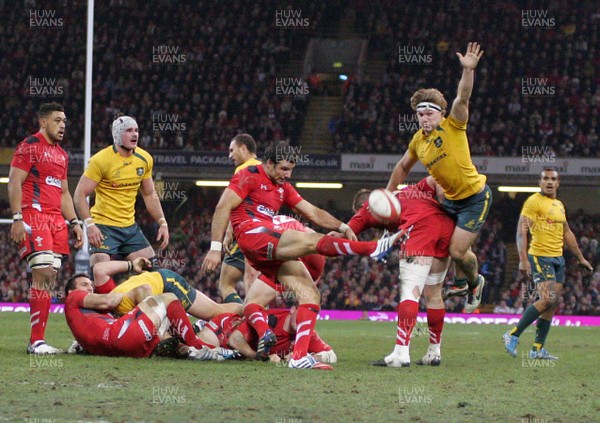 301113 - Wales v Australia - Dove Men+Care Series - Mike Phillips of Wales clears the ball under pressure from Michael Hooper of Australia