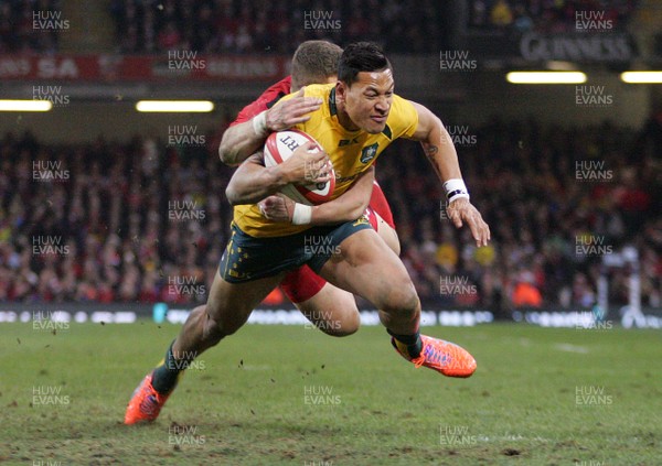 301113 - Wales v Australia - Dove Men+Care Series - Isreal Folau of Australia is tackled by Scott Williams of Wales