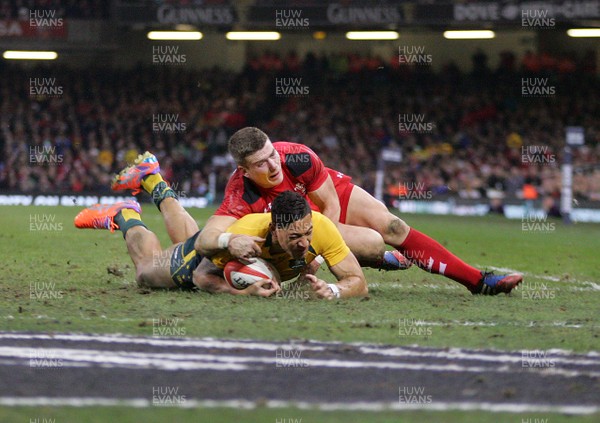 301113 - Wales v Australia - Dove Men+Care Series - Isreal Folau of Australia is tackled by Scott Williams of Wales