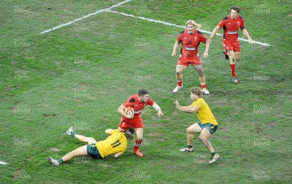 301113 - Wales v Australia - Dove Mens Series -Alex Cuthbert of Wales is tackled by Nick Cummins of Australia