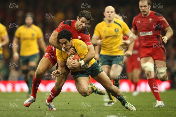 301113 - Wales v Australia, Dove Men Care Autumn Series - Mike Phillips of Wales tackles Joe Tomane of Australia