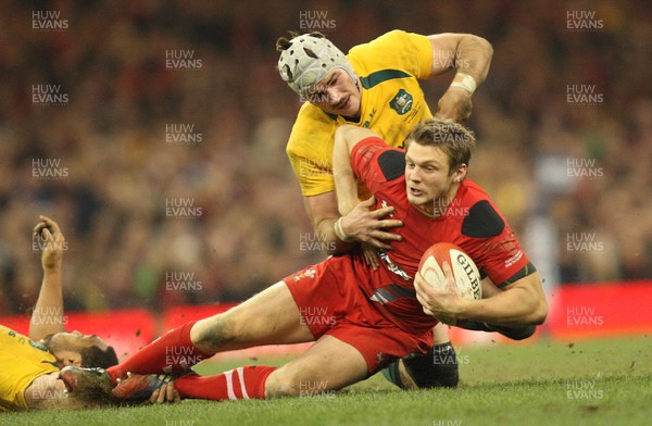 301113 - Wales v Australia, Dove Men Care Autumn Series - Dan Biggar of Wales is tackled by Ben Mowen of Australia