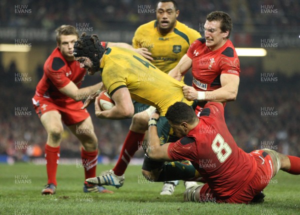 301113 - Wales v Australia, Dove Men Care Autumn Series - Rob Simmons of Australia is tackled by Toby Faletau of Wales and Sam Warburton of Wales