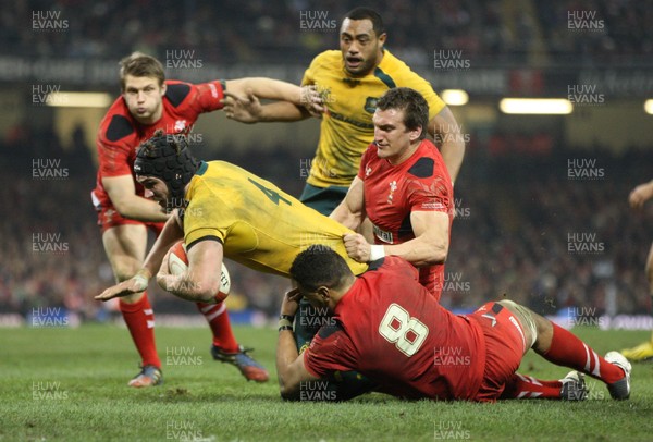 301113 - Wales v Australia, Dove Men Care Autumn Series - Rob Simmons of Australia is tackled by Toby Faletau of Wales and Sam Warburton of Wales