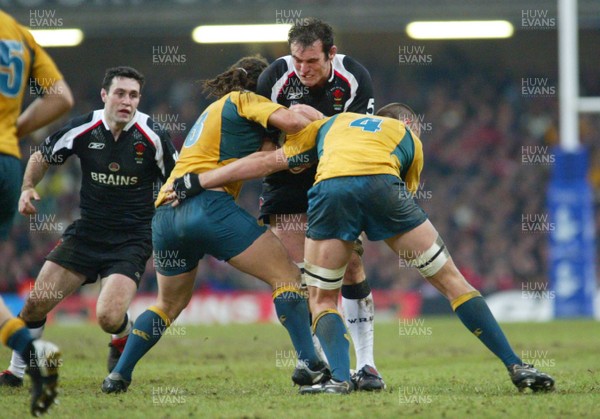 26.11.05... Wales v Australia, Millennium Stadium, Cardiff Wales' Robert Sidoli is tackled by George Smith and Hugh McMeniman 