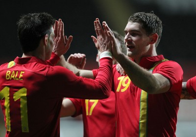 060213 - Wales v Austria, Vauxhall International Friendly Match, Swansea - Wales' Gareth Bale celebrates with Wales' Sam Vokes after Wales' second goal