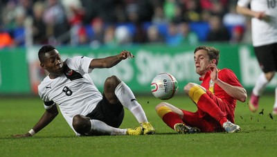 060213 - Wales v Austria, Vauxhall International Friendly Match, Swansea - Wales' Andrew King and Austria's David Alaba tangle as they go for the ball