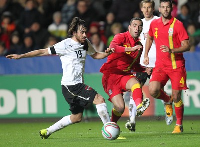 060213 - Wales v Austria, Vauxhall International Friendly Match, Swansea - Wales' Hal Robson-Kanu  fires over a cross as Austria's Veli Kavlak closes in