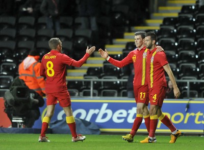 060213 - Wales v Austria - Vauxhall International Friendly Match - Swansea  -  Gareth Bale of Wales', middle, celebrates scoring with Craig Bellamy and Joe Ledley 