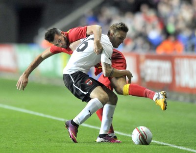 060213 - Wales v Austria - Vauxhall International Friendly Match - Swansea  -  Joe Ledley of Wales, right, battles for the ball with Austria's Jakob Jantscher 