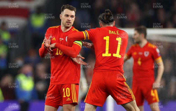 240322 - Wales v Austria - World Cup Qualifying - European - Path A - Gareth Bale gives Aaron Ramsey of Wales the captains armband