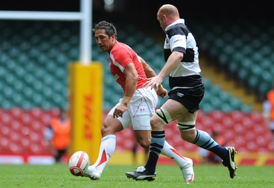 04.06.11 - Wales v Barbarians - DHL Challenge - Gavin Henson of Wales kicks the ball past Martyn Williams of Barbarians. 