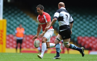 04.06.11 - Wales v Barbarians - DHL Challenge - Gavin Henson of Wales kicks the ball past Martyn Williams of Barbarians. 
