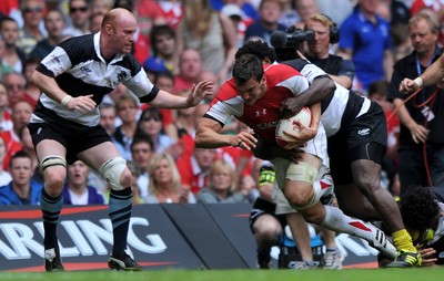 04.06.11 - Wales v Barbarians - DHL Challenge - Sam Warburton of Wales is tackled by Martyn Williams and Seru Rabeni of Barbarians. 