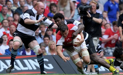 04.06.11 - Wales v Barbarians - DHL Challenge - Sam Warburton of Wales is tackled by Martyn Williams and Seru Rabeni of Barbarians. 
