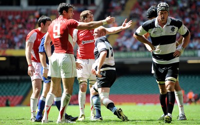04.06.11 - Wales v Barbarians - DHL Challenge - Mike Phillips and Ryan Jones of Wales appeal to the linesman as Martyn Williams of Barbarians gets up from the ground. 